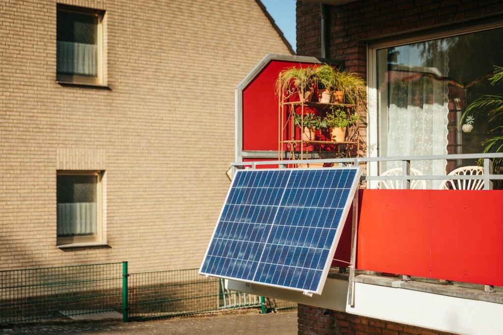 Solar panel on a balcony with plants